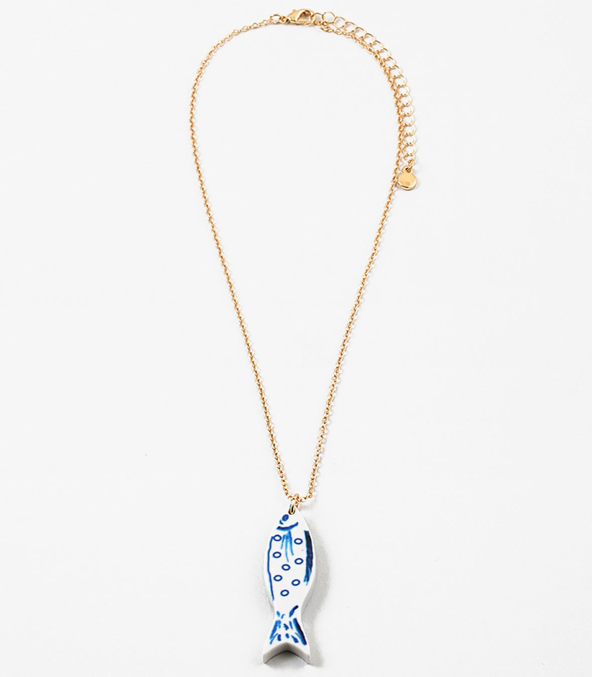 Necklace with a blue and white fish pendant on a white background