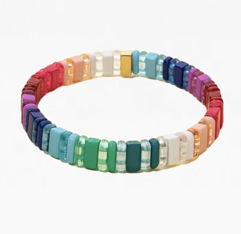 Picture of a bead bracelet in greens, whites, pinks, reds, purples and blues