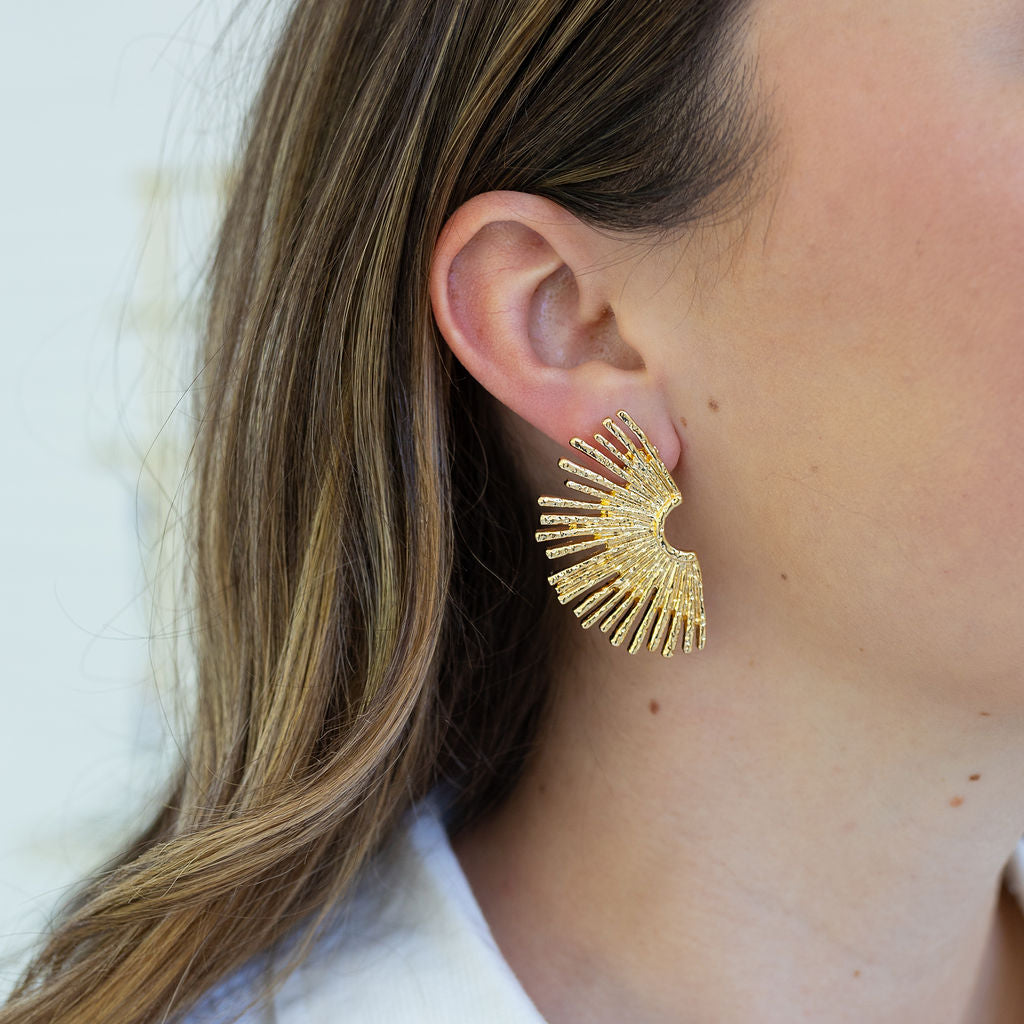 Picture of a large gold half moon starburst earring.