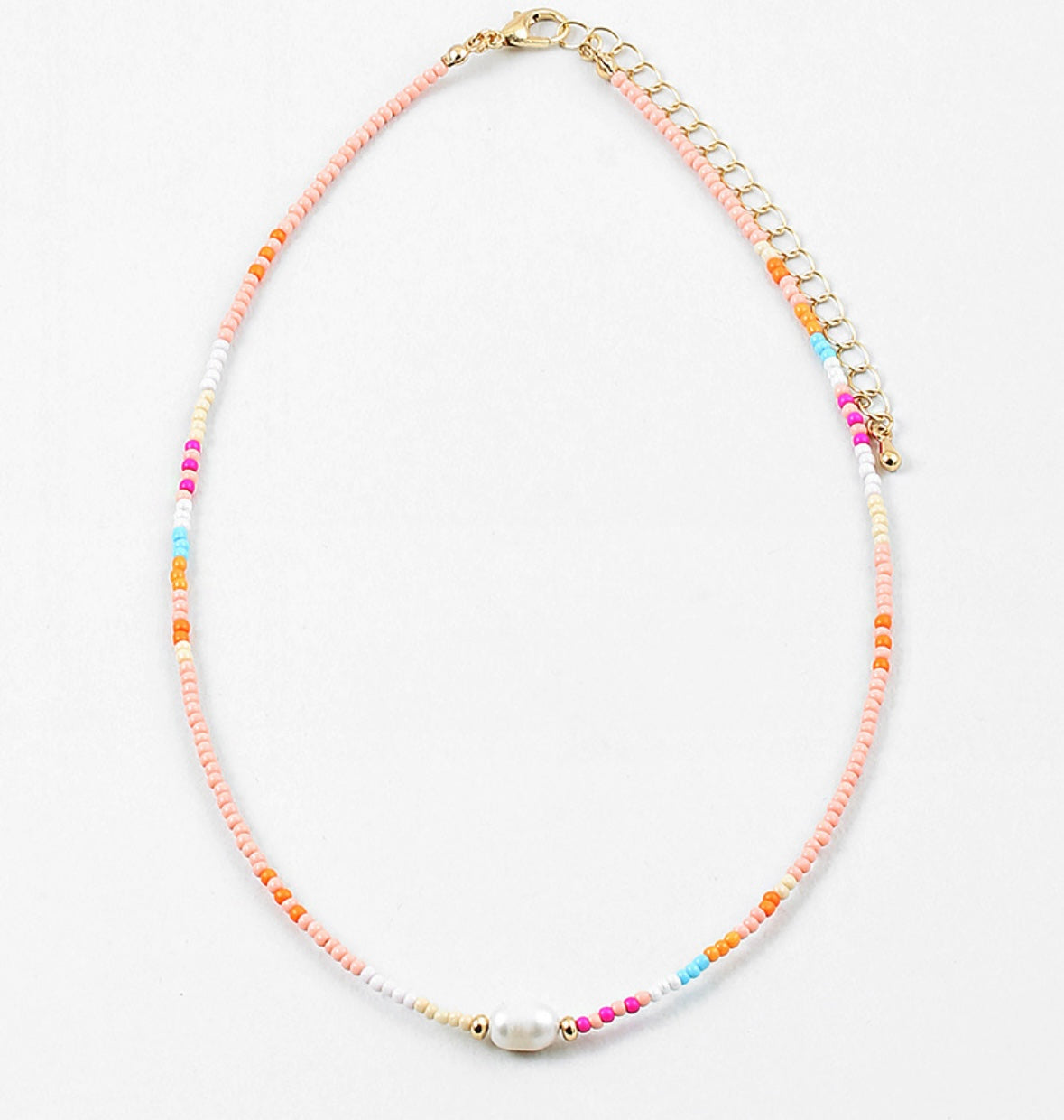 Necklace with multicolored beads in pinks, blues and whites with a freshwater pearl on a white background