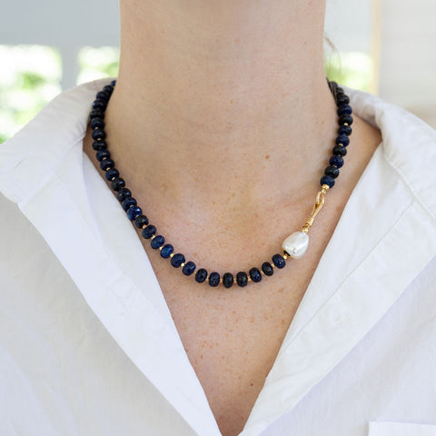 Picture of a black bead necklace with one freshwater Pearl bead.