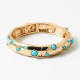 Gold cuff style bracelet with turquoise beads inlaid.