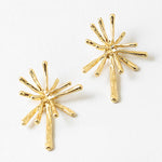 Pair of gold starburst earrings on a white background