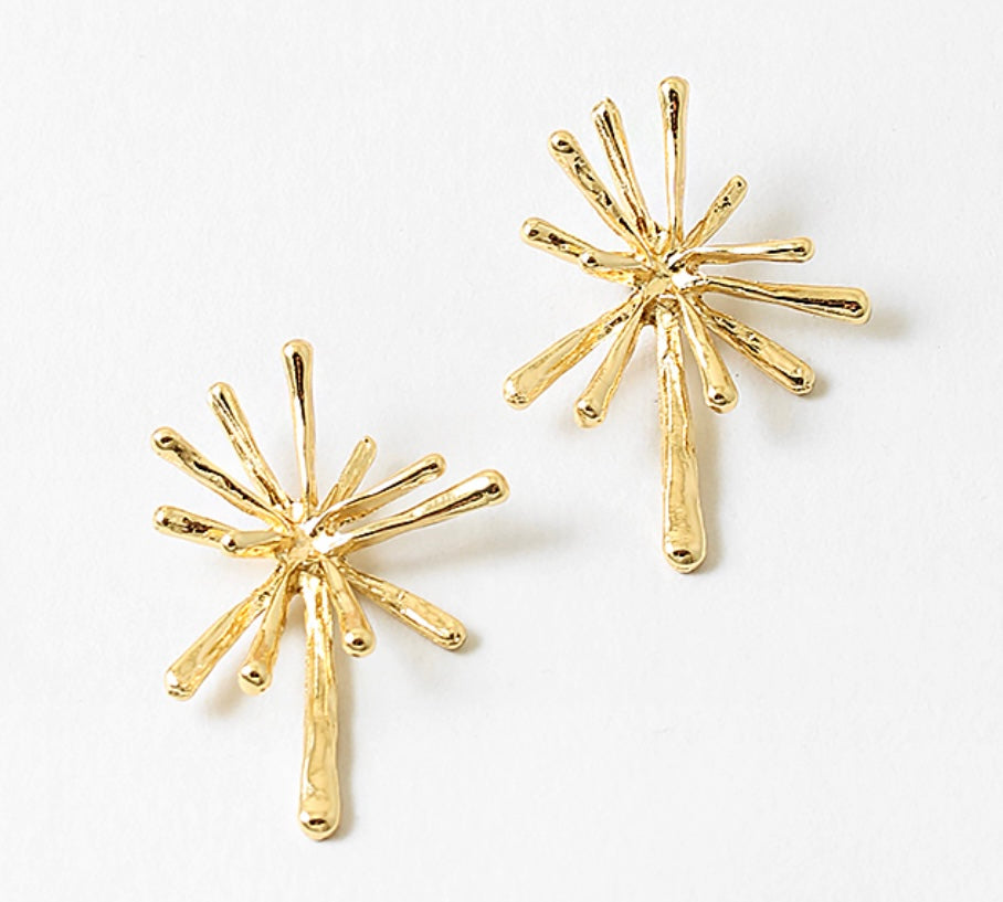 Pair of gold starburst earrings on a white background
