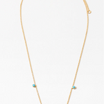 Picture of dainty gold necklace with five small turquoise bead pendants dangling at the front.