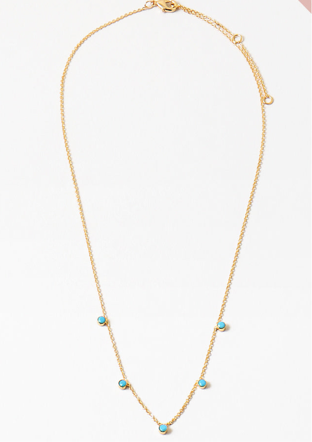 Picture of dainty gold necklace with five small turquoise bead pendants dangling at the front.