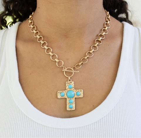 Large gold circle link chain with a toggle clasp and a large gold Cross with turquoise stones.