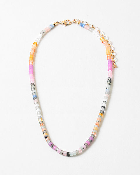 Picture of a lightly colored beaded necklace in oranges, pink, whites and grays.