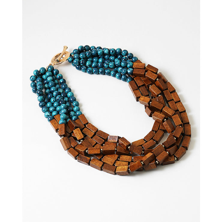 Necklace with blue beads and brown wooden beads on a white background