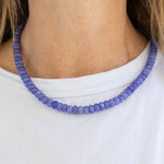 Model wearing a blue resin bead necklace.
