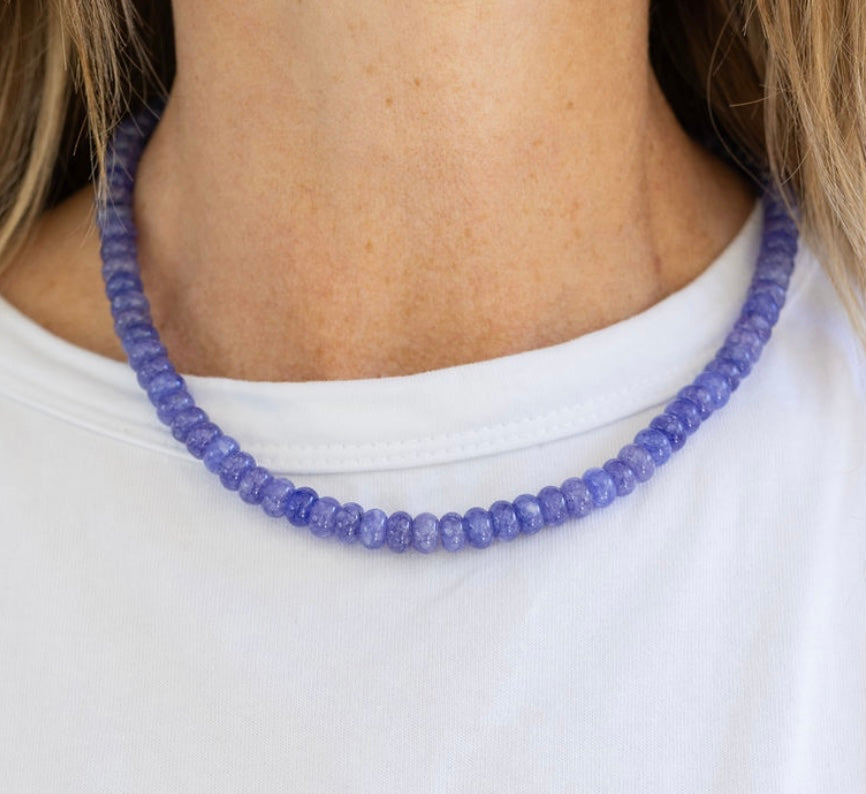 Model wearing a blue resin bead necklace.