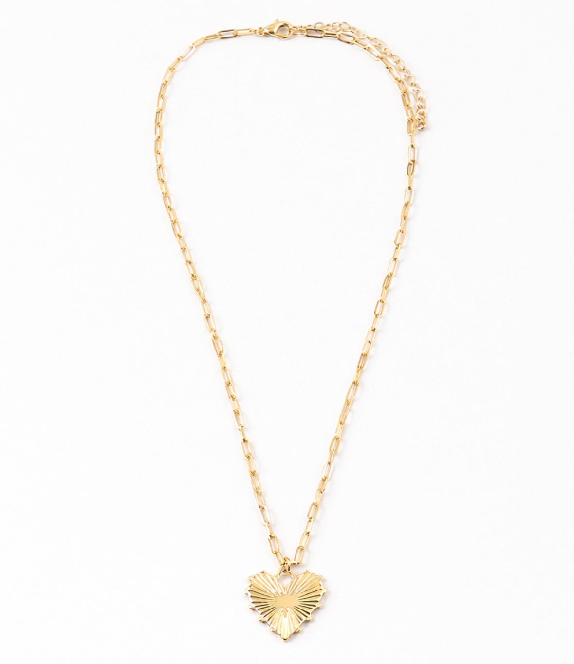 Gold necklace with a heart-shaped pendant on a white background