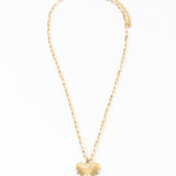 Gold necklace with a heart-shaped pendant on a white background