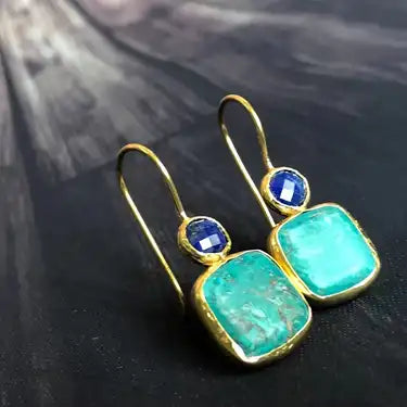 Gold Teardrop earrings with a small blue stone and a turquoise square stone underneath.