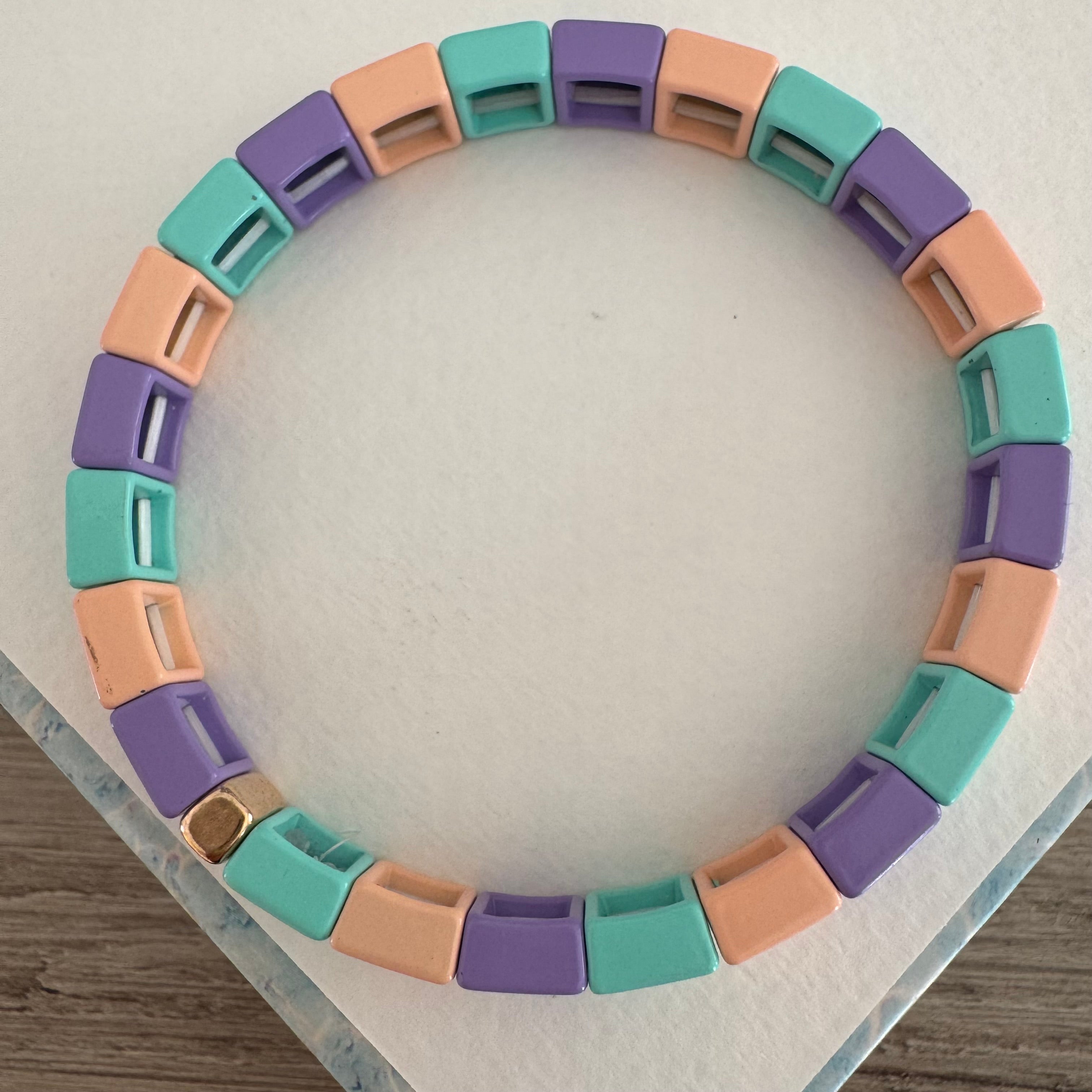Square bead bracelet in coral, teal and lavender.