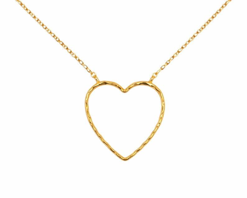Gold heart-shaped necklace on a white background