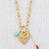 Picture of gold toggle chain with a turquoise teardrop, a large gold heart pendant with a diamond center and a gold matchstick.