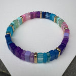Picture of a multicolored bead bracelet in mostly purples, blues, green and pink.