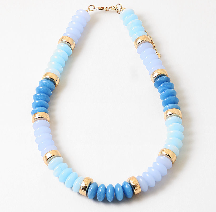 Chunky bead necklace in hues of opaque blues and gold spacer beads.