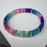 Picture of a multicolored bead bracelet in shades of mostly blues, green, pink and purples.