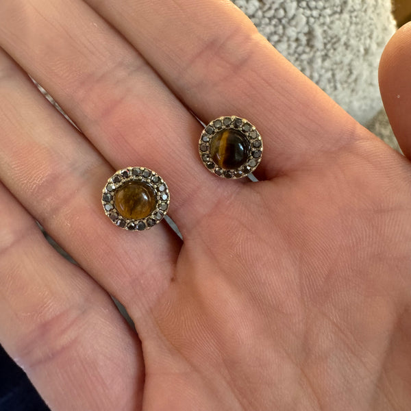 Picture or cat eye studs with gold and stone border.