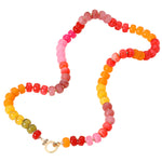 Bright bead necklace in shades of pink, orange and yellows with a large gold clasp.