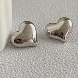 Picture of small silver bubble heart earrings.