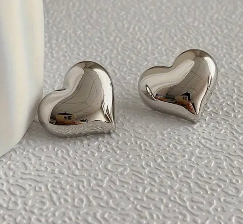 Picture of small silver bubble heart earrings.