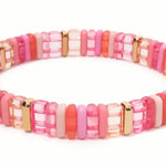 Bead bracelet in clear and solid pinks and Gold accent beads.