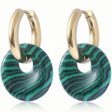 Set of earrings with small gold hoops that have green striped discs threaded through them.