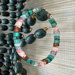 Picture of a bead bracelet in teals, pinks, browns and clear beads.