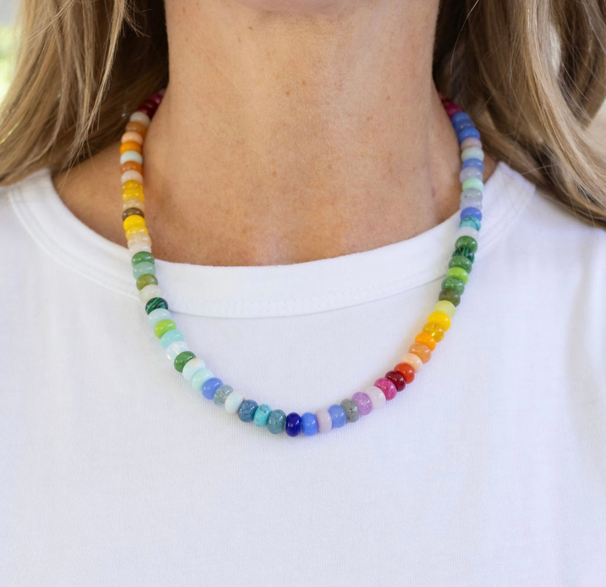 Bright multicolored bead necklace in mostly greens, blues and yellows.