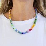 Bright multicolored bead necklace in mostly greens, blues and yellows.