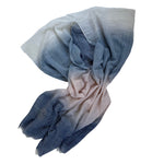 Folded fabric with blue and beige gradient on a white background