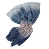Folded fabric with blue and beige gradient on a white background