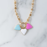 Picture of gold toggle chain with blue, white and pink heart pendants.