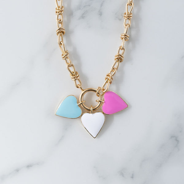 Picture of gold toggle chain with blue, white and pink heart pendants.