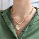 Woman wearing a gold heart toggle necklace