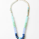 Necklace with blue and green beads on a white background