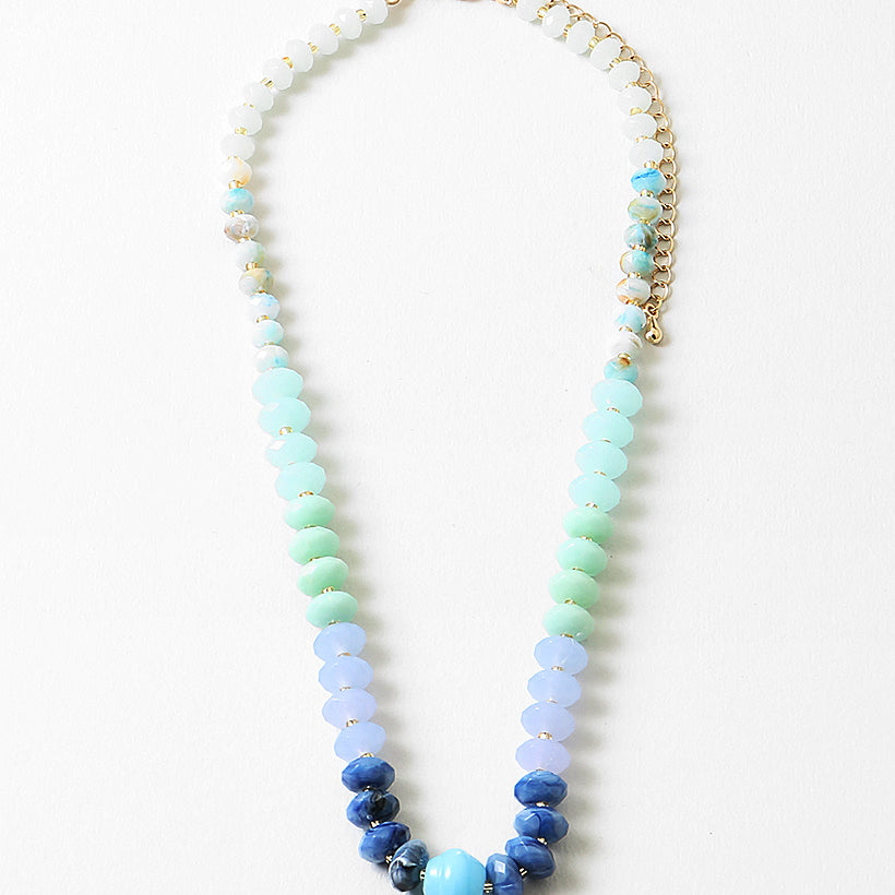 Necklace with blue and green beads on a white background
