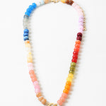 Multicolor bead necklace in blues, reds, corals, yellows, greens, reds and pinks with a large toggle clasp at its center.