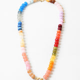 Multicolor bead necklace in blues, reds, corals, yellows, greens, reds and pinks with a large toggle clasp at its center.