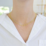 Picture of woman wearing a dainty yellow bead necklace.