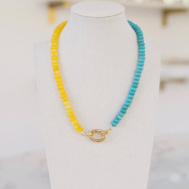Yellow and turquoise colored beaded necklace with a gold clasp.