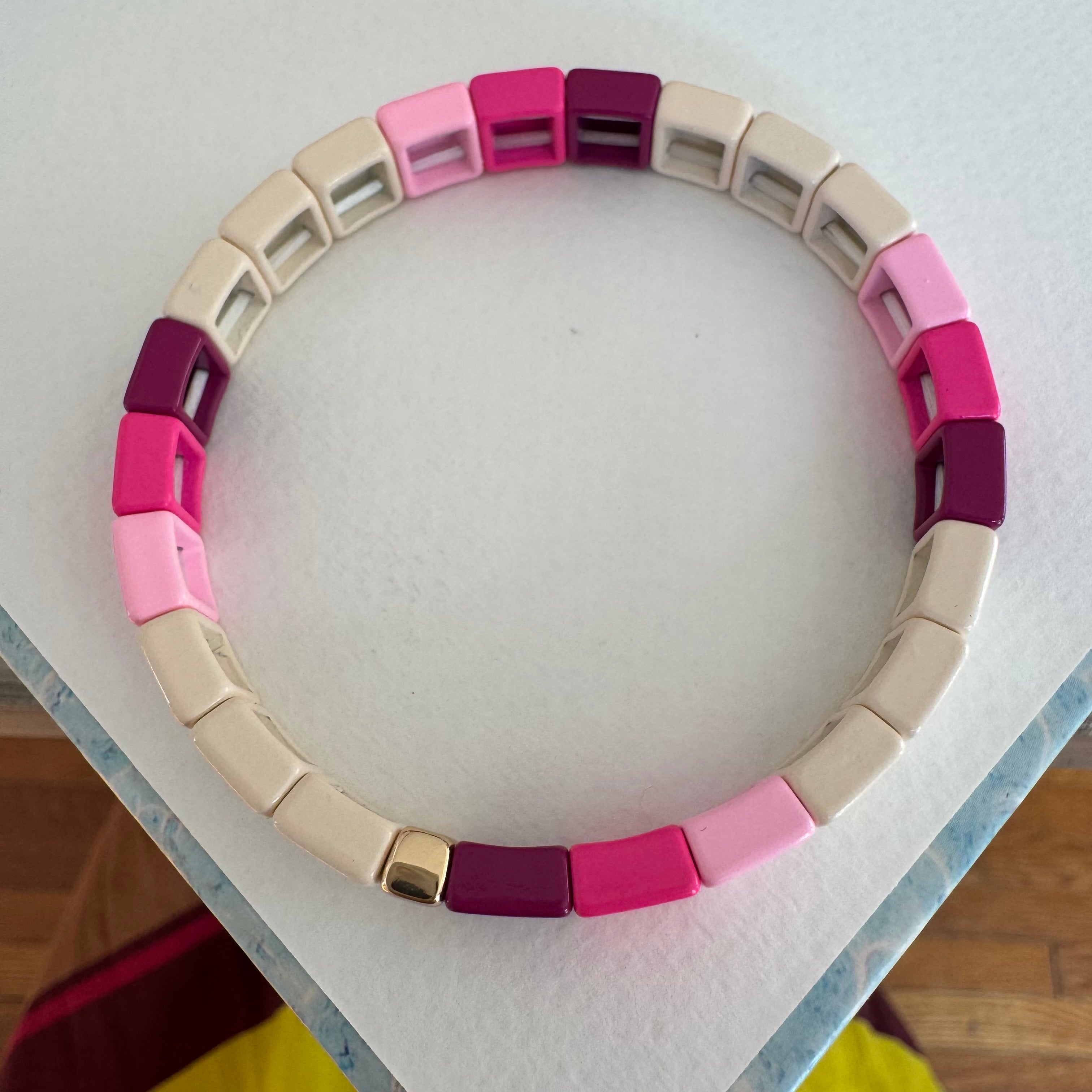 Square bead bracelet in ombre pinks and beige.