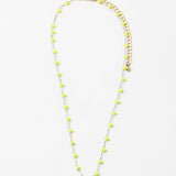 A gold-colored necklace with neon yellow beads and a clasp, displayed against a white background.