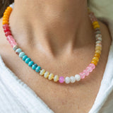 Girl wearing a light multi-colored beaded short necklace around her neck