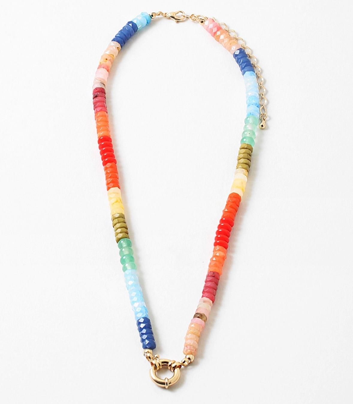 Brightly colored bead necklace with orange, yellow, blues and green beads. Necklace has a large gold clasp at its center.