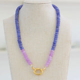 Picture of a blue periwinkle colored bead necklace with a section of light purple beads and a large gold carabiner clasp.