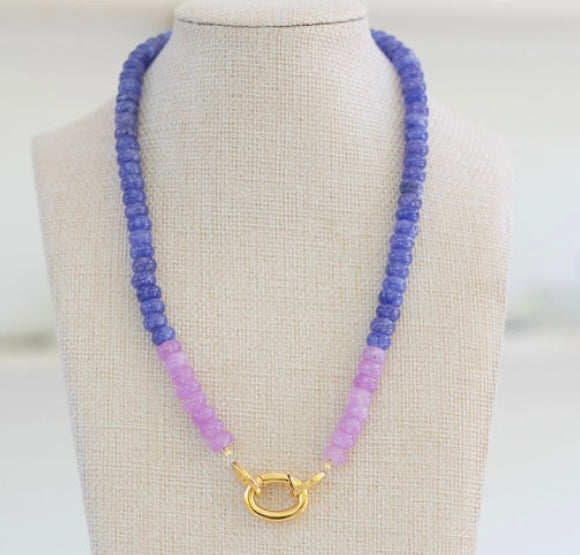 Picture of a blue periwinkle colored bead necklace with a section of light purple beads and a large gold carabiner clasp.